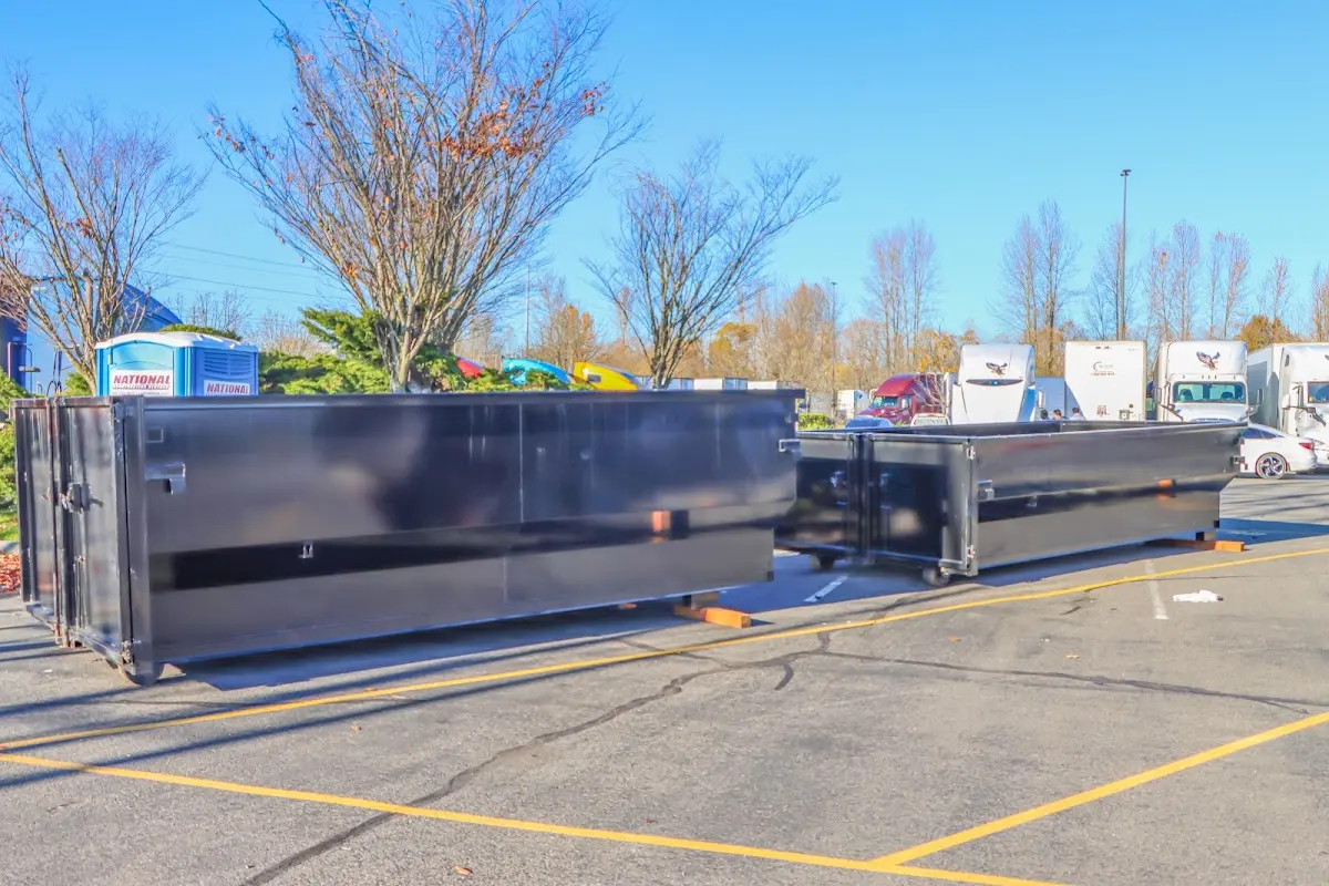 Professional dumpster rental service with roll-off container on residential driveway in Torrington